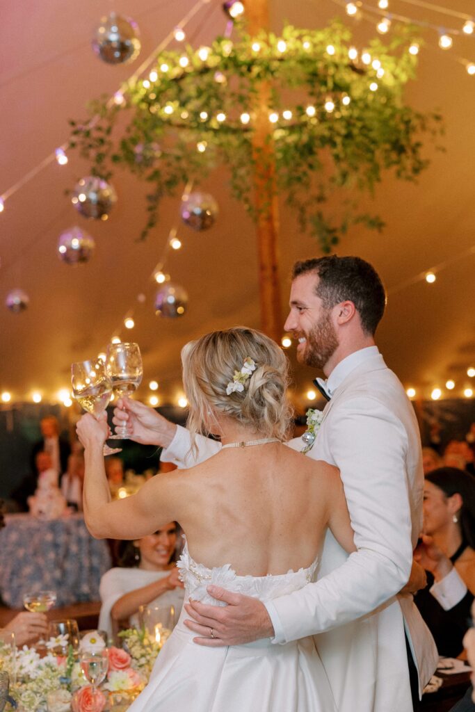 Bride and groom toast during Martha's Vineyard tented wedding