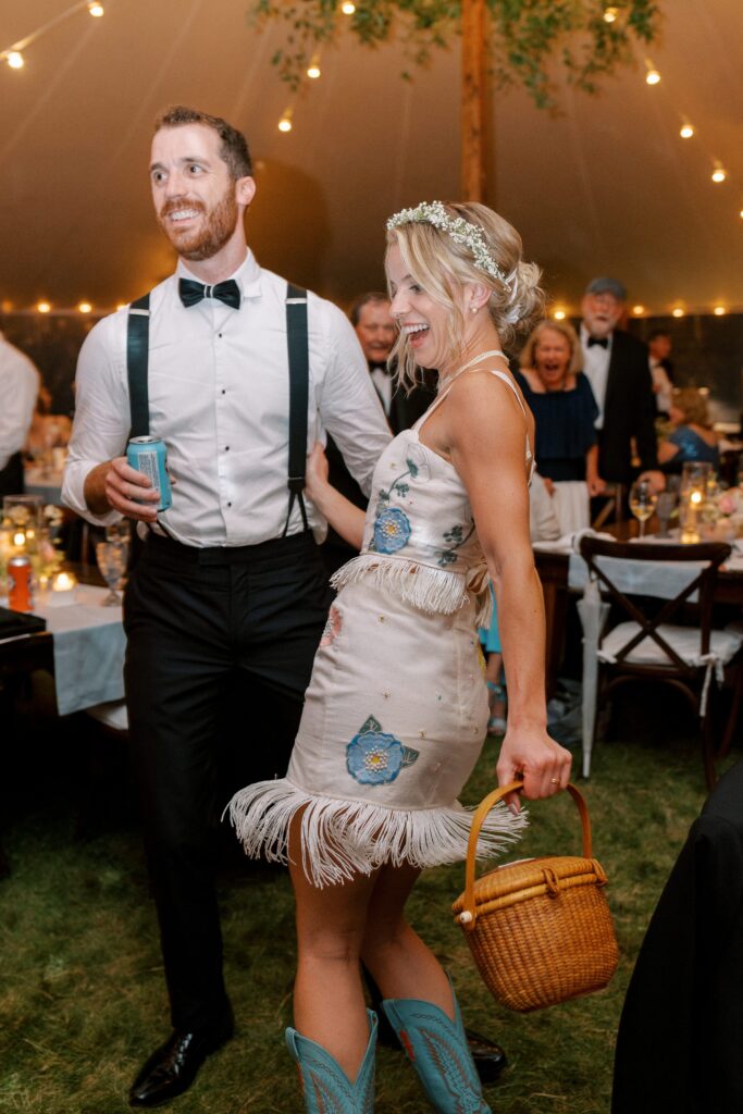 Brides outfit change at reception with cowgirl boots and pressed flowers