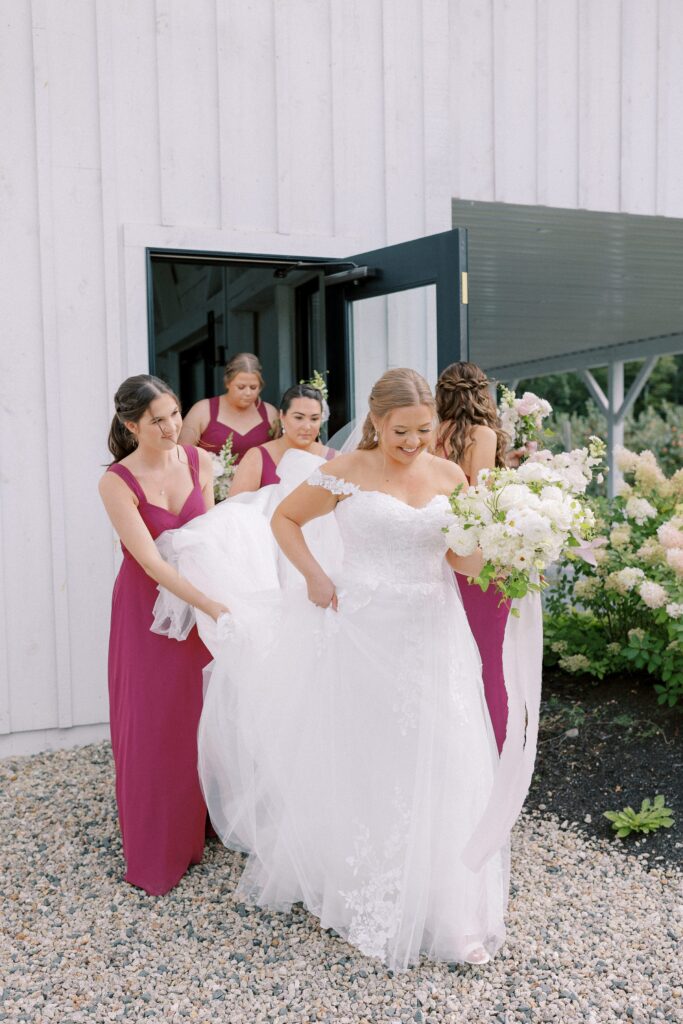 Bride and bridesmaids walking outside for portraits for The Greenery at McKenzie's Farm Wedding