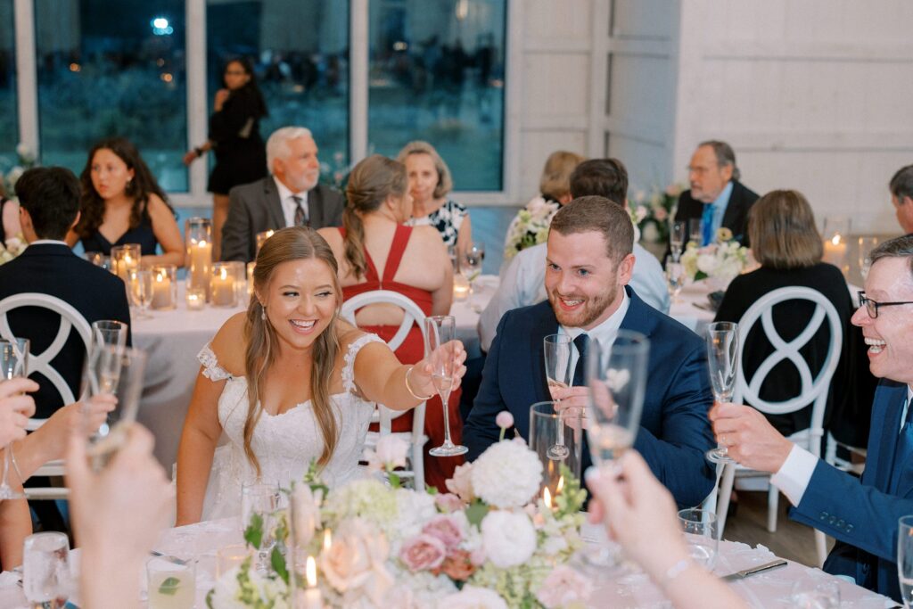 Bride and groom toast during New England wedding candid portraits 