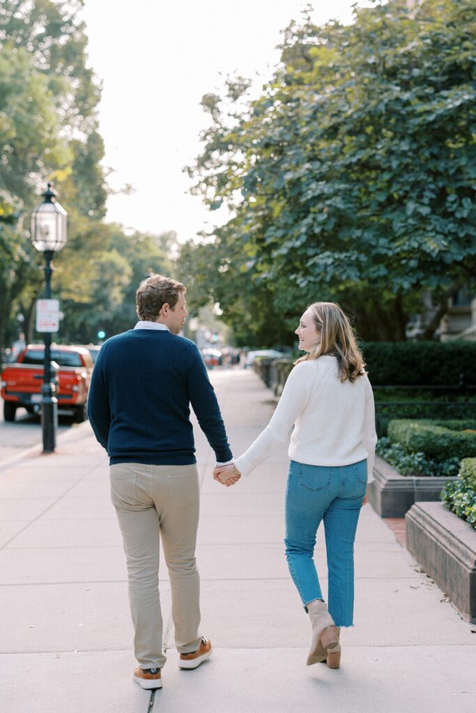 Couple walking hand in hand on Comm Ave in Boston