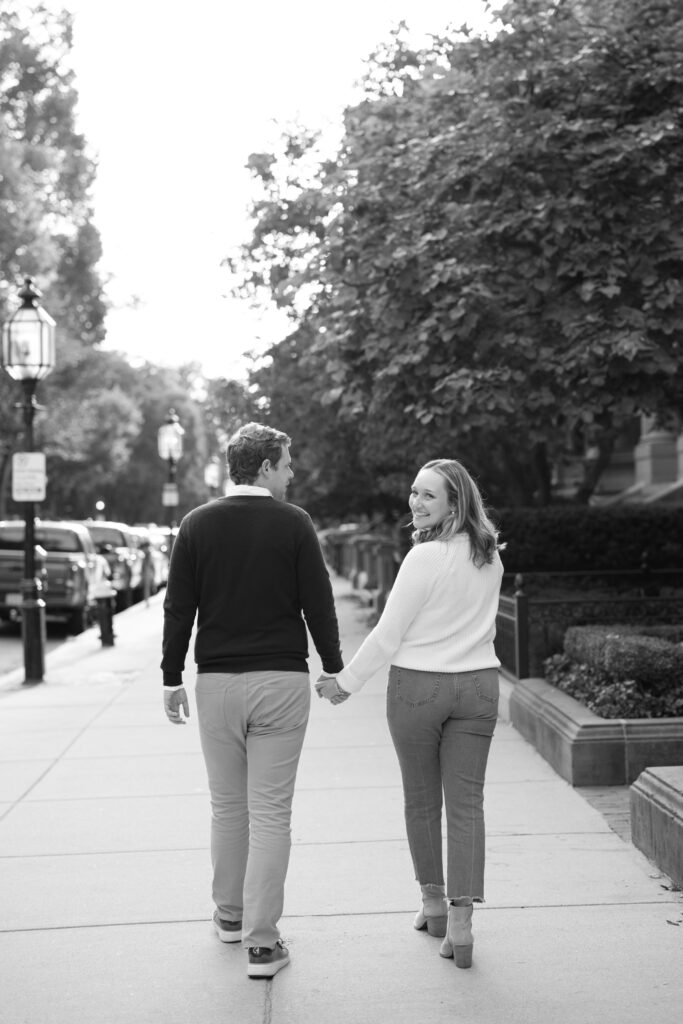 Couple walking hand in hand on Comm Ave in Boston
