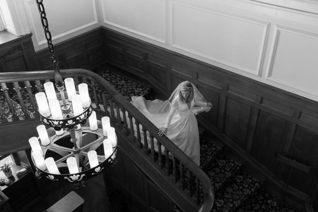 Bride walking down the stairs at New York Yacht Club Harbour Court in Newport