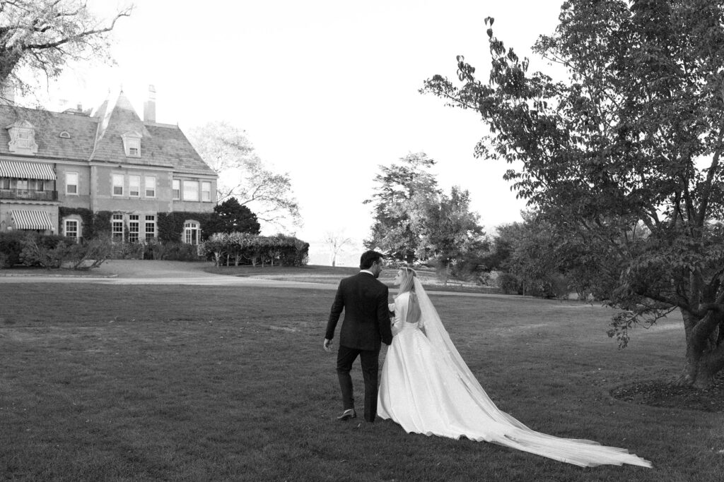 Black and white portrait of bride and groom on the lawn at New York Yacht Club Harbour Court in Newport