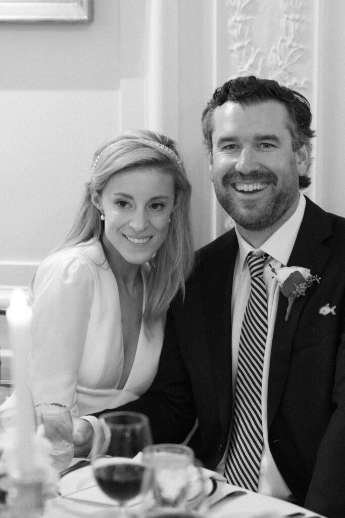 Candid black and white photo of bride and groom at reception during Newport wedding