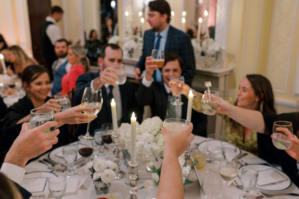 Guests cheersing during reception at the New York Yacht Club Harbour Court in Newport, RI