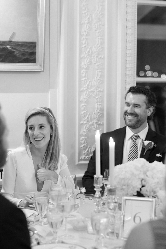 Bride and groom faces during toasts during Newport wedding